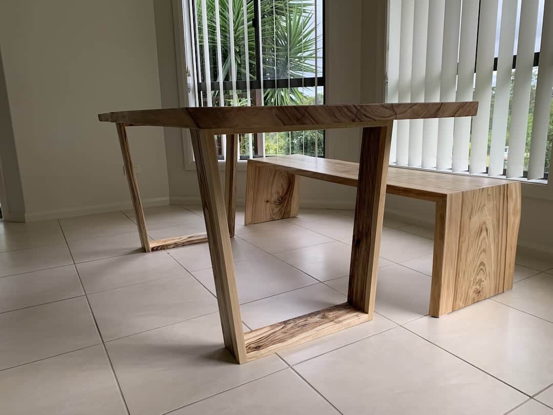 custom-dining-table-bench-view-2 Side view of the dining table and bench with waterfall legs custom made from Camphor Laurel