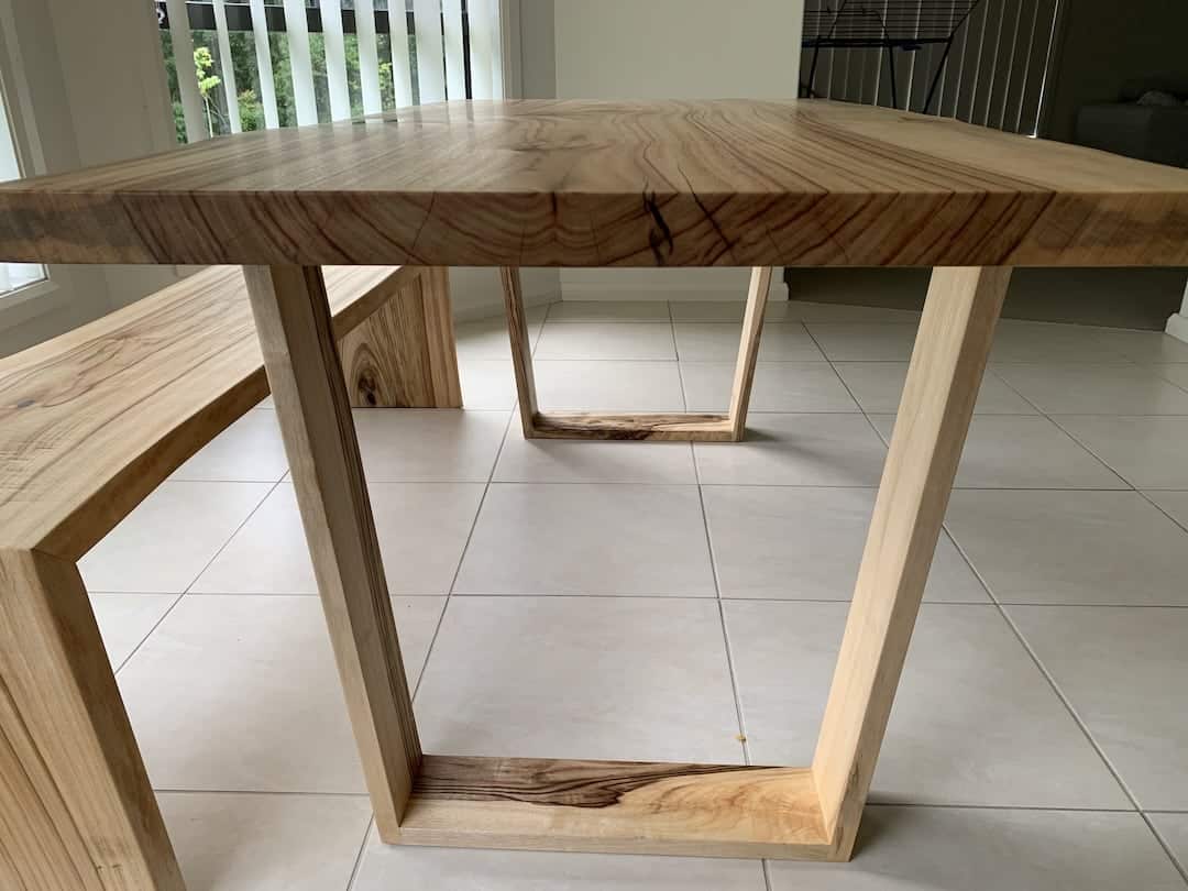 custom-dining-table-bench-view-4 Close up view of the dining table to show the timber trapezoidal legs with beautiful wood grain