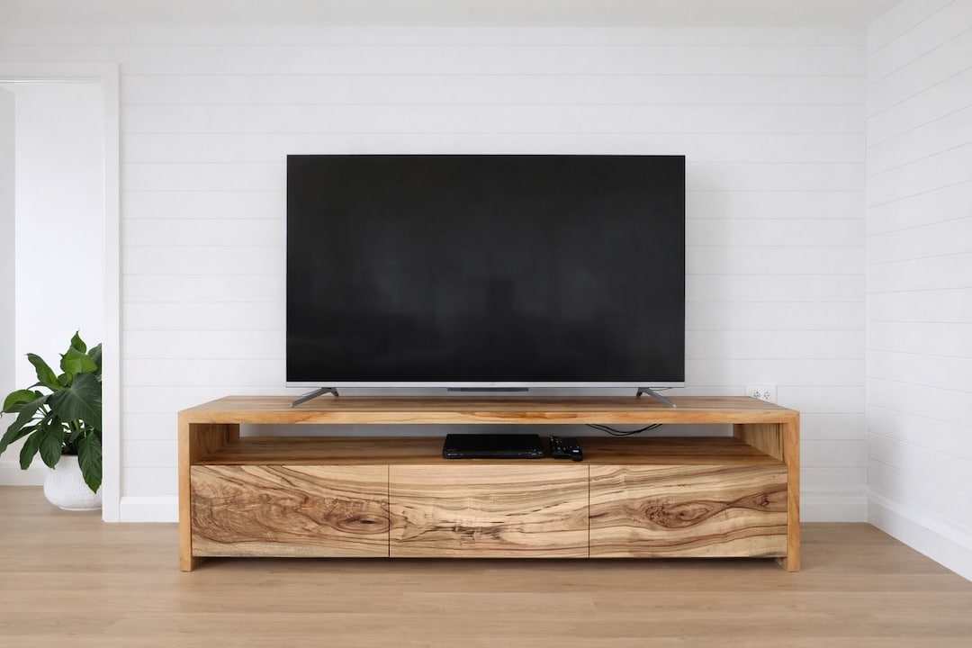 Front view of the tv cabinet showing the continues wood grain flow for the three door fronts