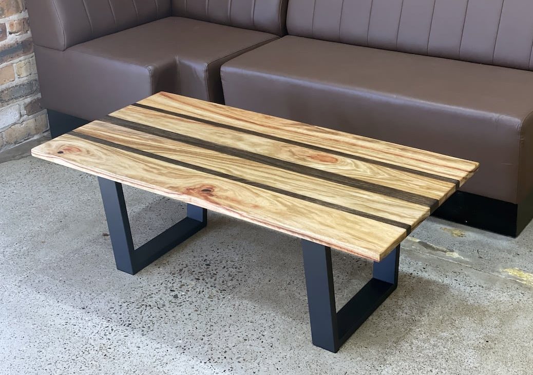 Custom built coffee table next to sofa in the client shop