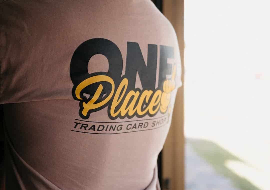 Person wearing one place trading cards t-shirt