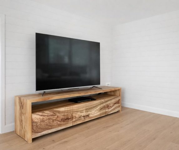custom-tv-cabinet-view-1 Side view of the tv cabinet showcasing the waterfall legs and continues flowing wood grain