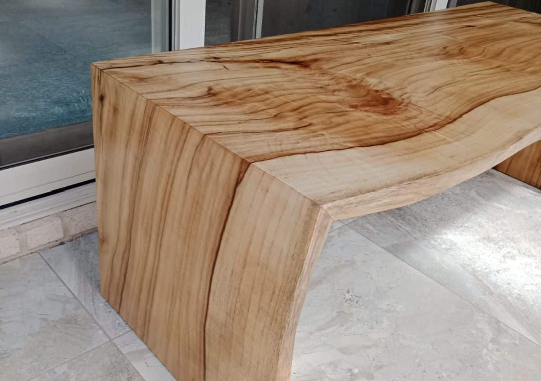 custon-built-pool-bench-view-2 Close up photo of the outdoor bench showing the 45 degree mitre cut legs for the waterfall legs with the grain matching perfectly