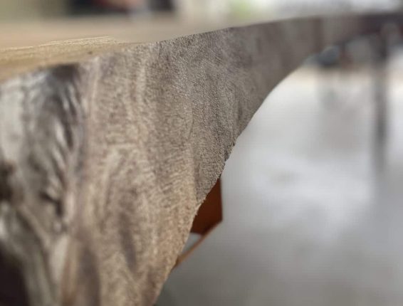 handmade-custom-live-edge-dining-table-make-4 Close up shop of timber slab edge all debarked and sanded