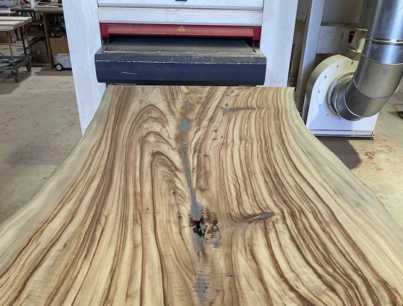 handmade-custom-live-edge-dining-table-make-7 Single slab dining table top sanded with large drum sander