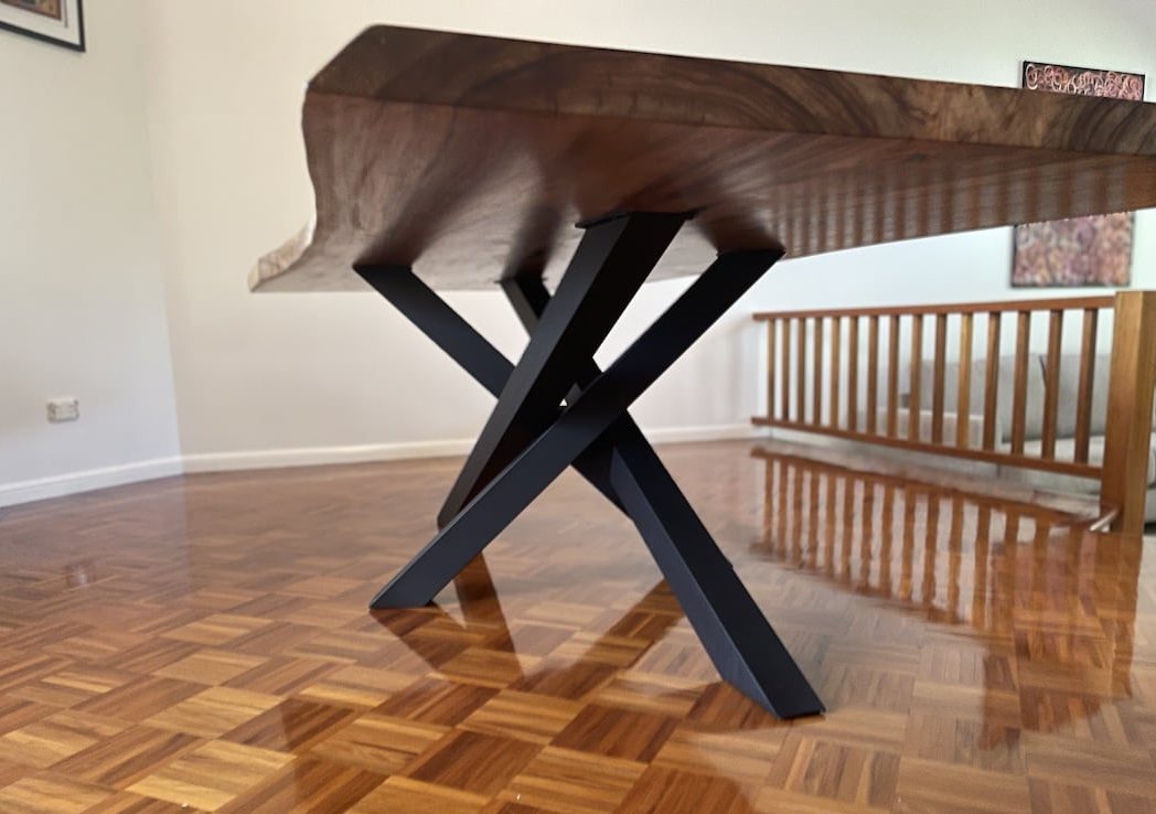 handmade-custom-live-edge-dining-table-view-2 Black steel legs close us under the large live edge dining table